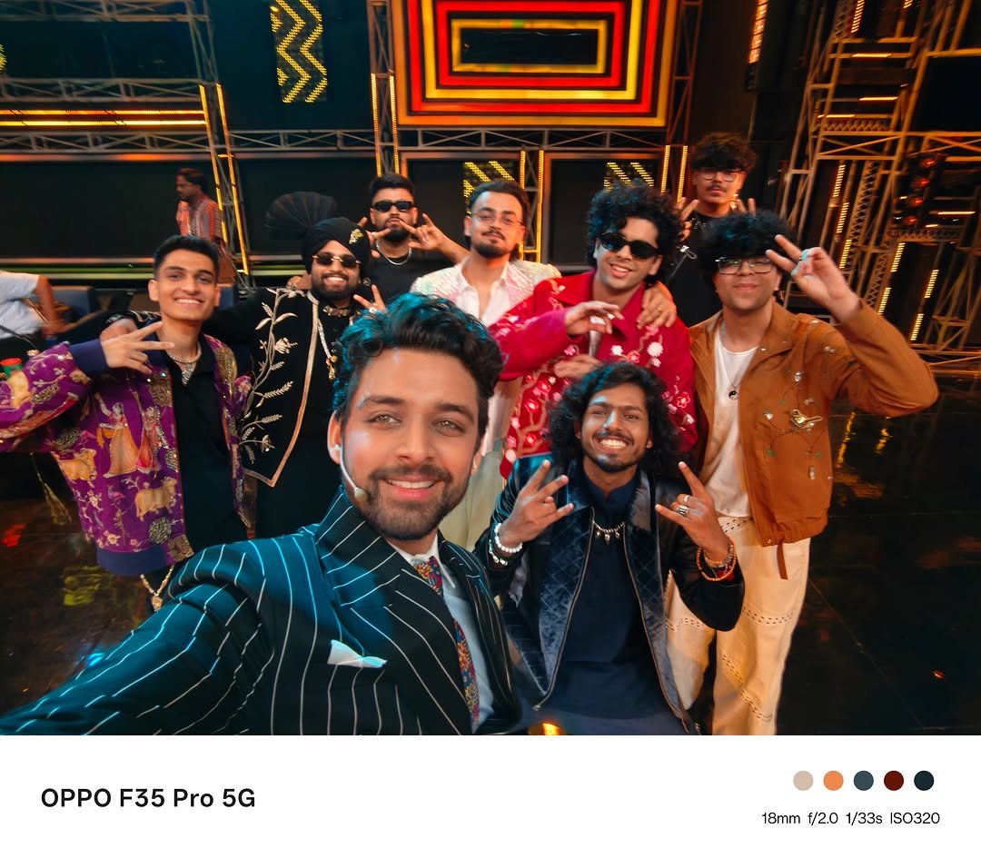 Samarth Jurel takes a group selfie on a colorful stage