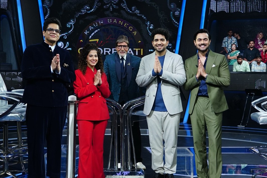 Tanmay Bhat stands with several people on a television set